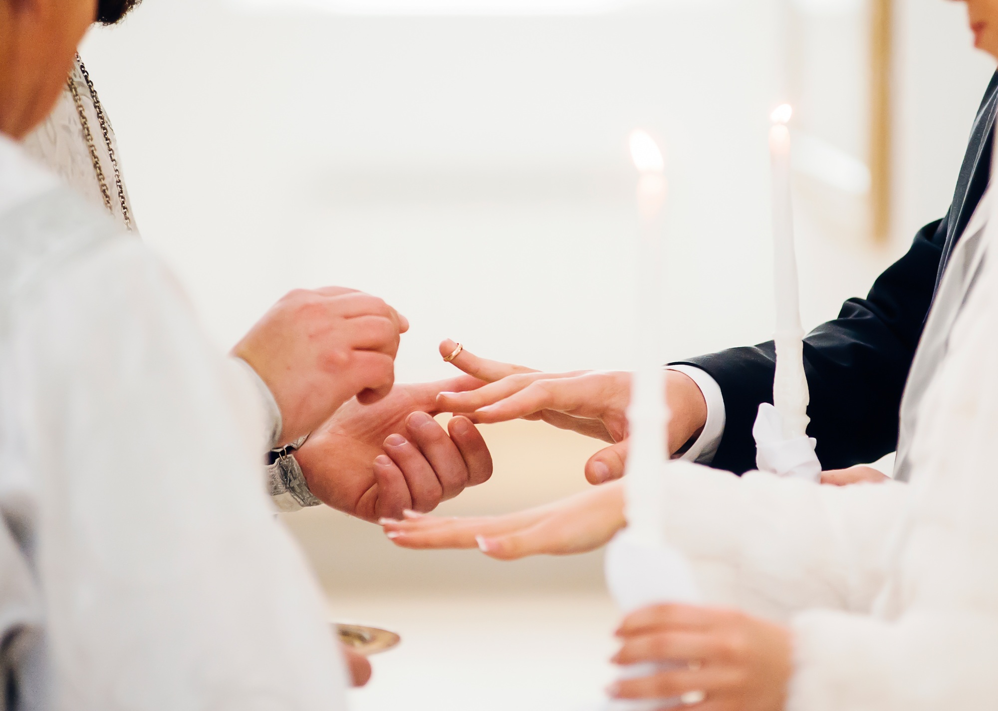 The priest puts on the ring at the wedding ceremony in the church