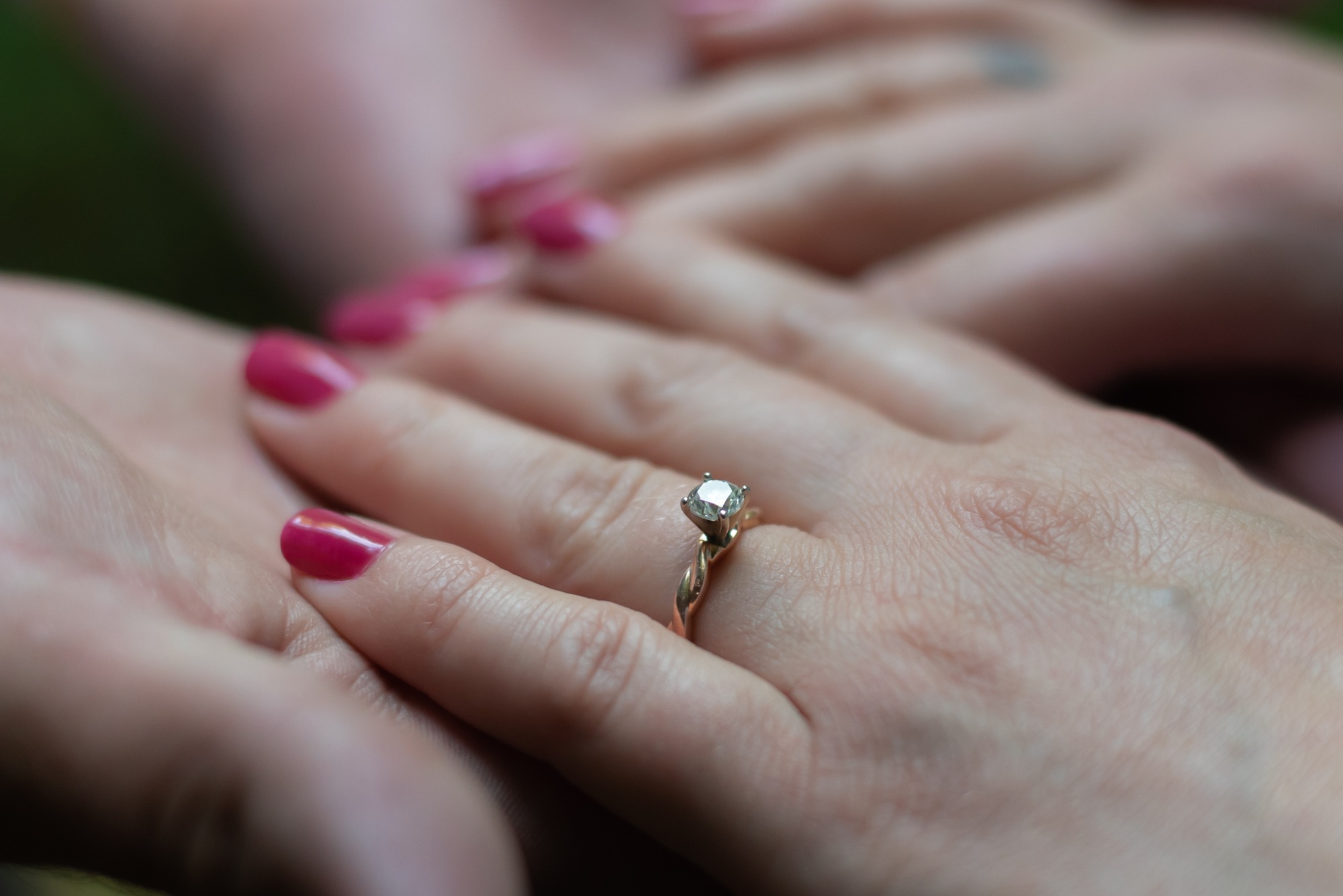 Hands touching with engagement ring